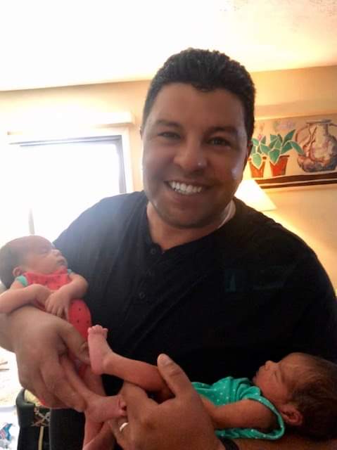 Armando Lopez of Its All About Satellites holding his twin girls