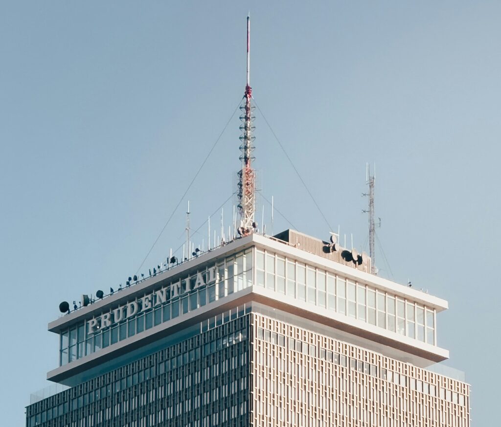 Hi-rise office building with multiple satellite dishes on the roof - Prudential Tower in Boston - Article by Its All About Satellites about Streaming TV for Business