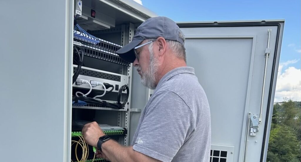 Ted Maes of RVParkTV.com by Its All About Satellites working on Wi-Fi and Streaming technology at Mylan Park KOA in Morgantown, WV